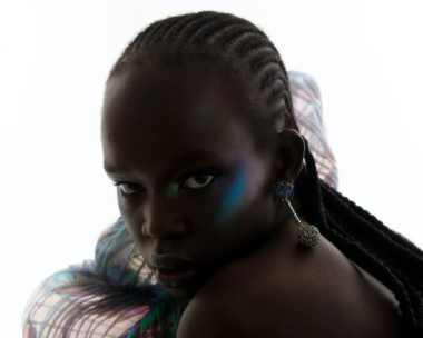 A black female model posing with an African hairstyle