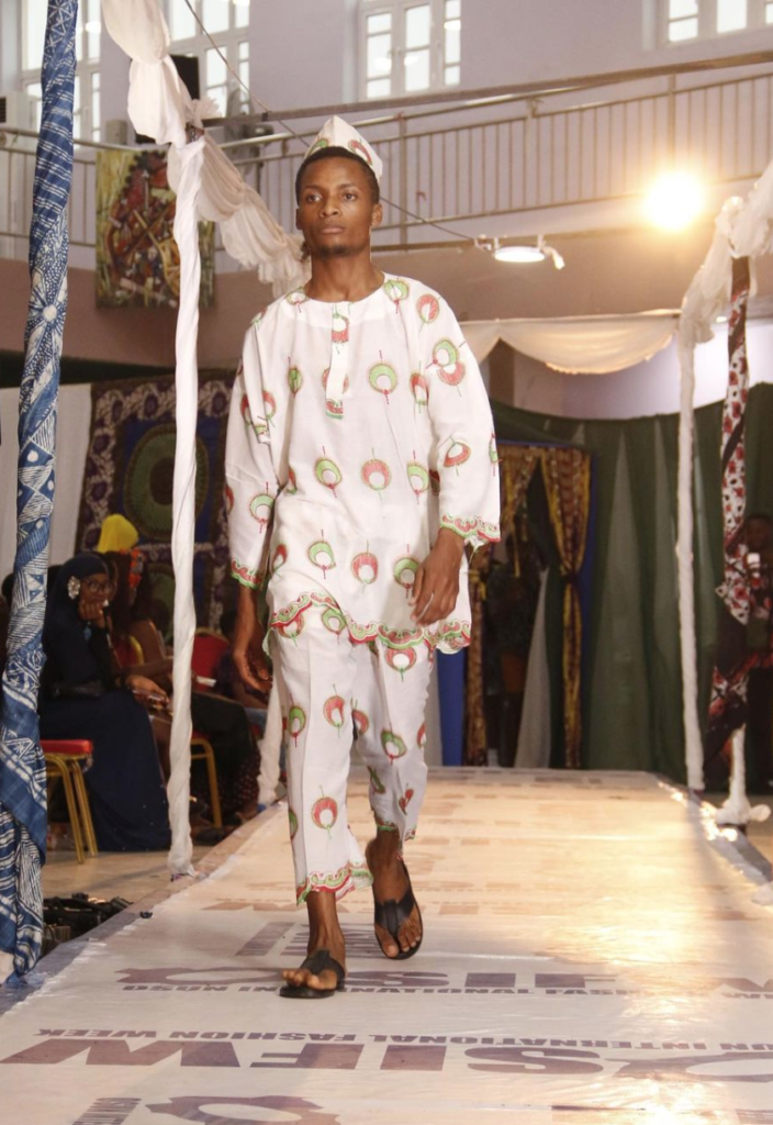 A model walking on Osun International Fashion Week Runway
