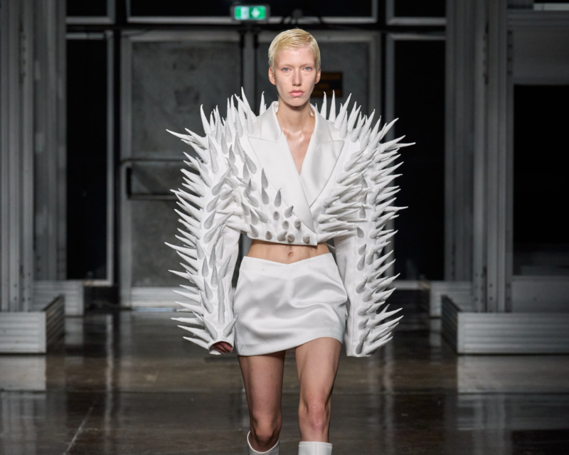 A white model wearing a piece from ANNAKIKI latest collection