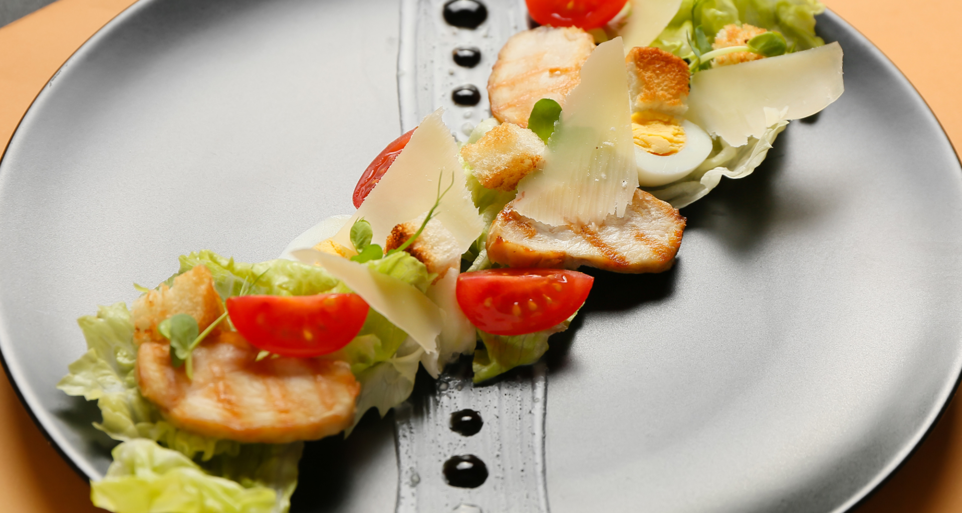 A black plate of food with a decorated meal