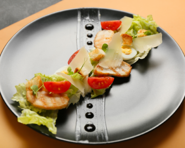 A black plate of food with a decorated meal