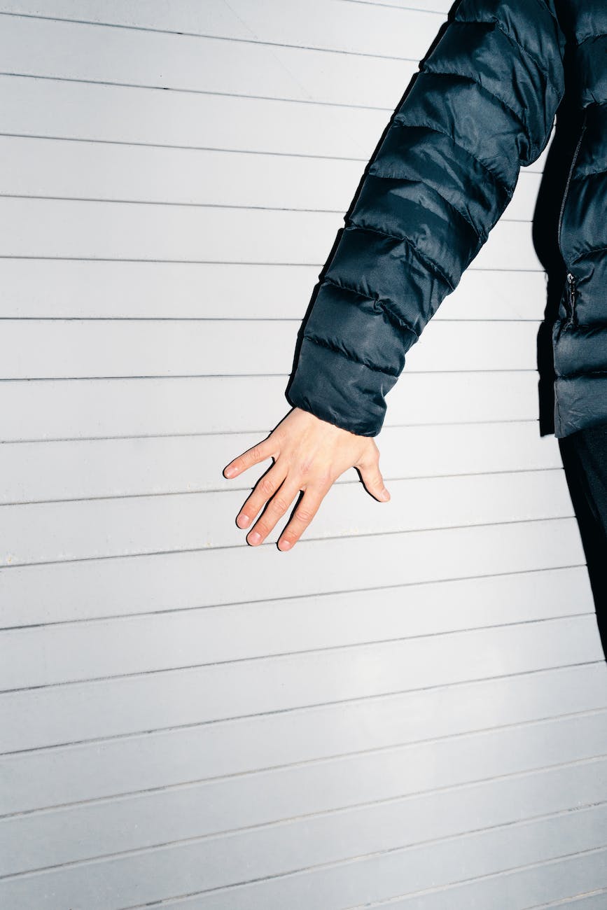 man standing against the wall and touching it