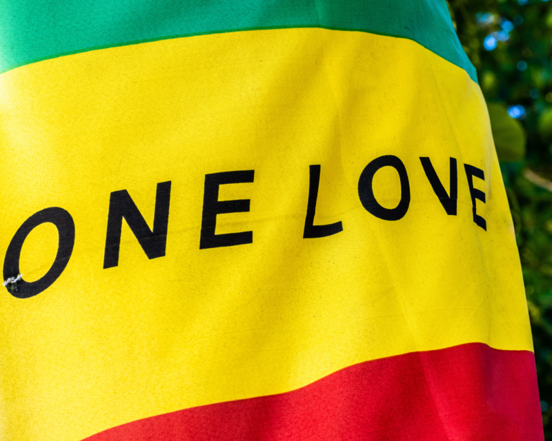 A flag symbolising Bob Marley roles of a musical prophet, standing for unity, freedom, and black resilience