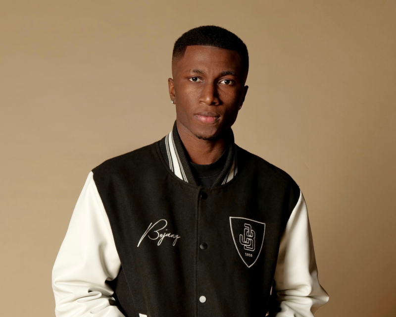 BOJANG's Aesthetic - Buba Bojang posing with his collection of timeless fashion garments, illustrating his unique style philosophy