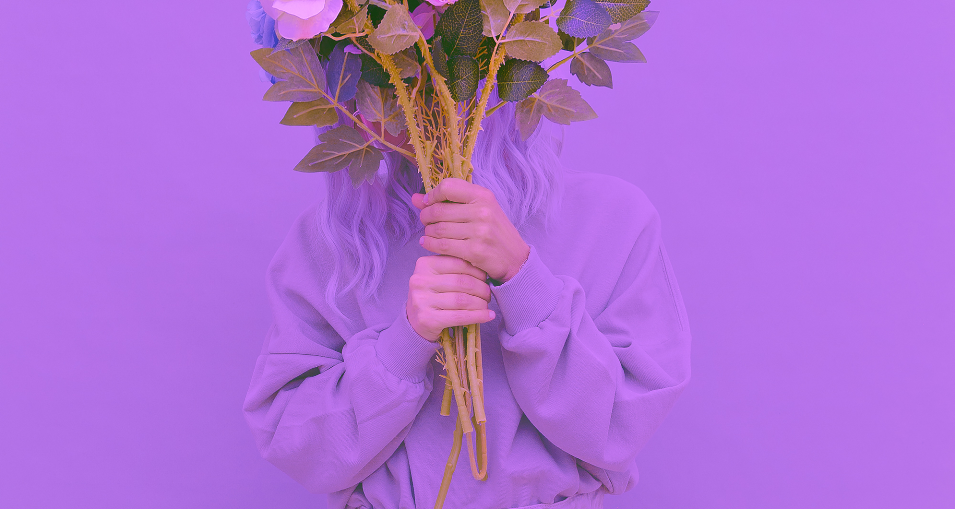 Creative display of a purple outfit laid out in celebration of International Women's Day, highlighting the significance of the color.