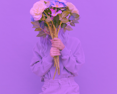 Creative display of a purple outfit laid out in celebration of International Women's Day, highlighting the significance of the color.