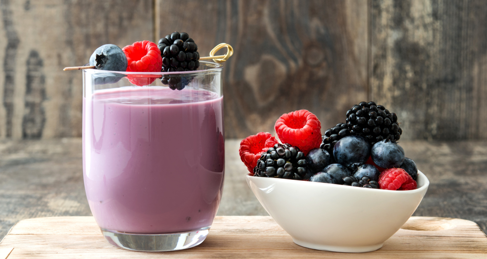 A colorful array of spring smoothie recipes made with fresh fruits and vegetables on a bright kitchen counter.