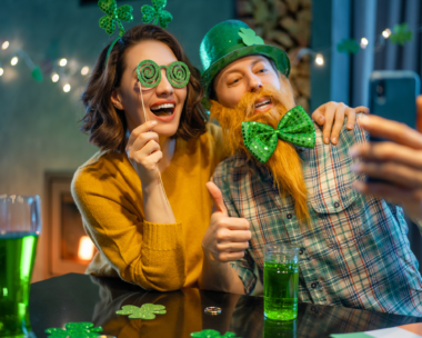Table set for St. Patrick's Day feast with green-themed dishes and shamrock decorations