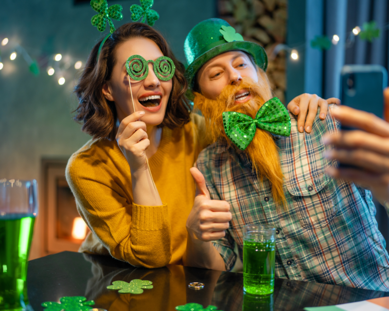 Table set for St. Patrick's Day feast with green-themed dishes and shamrock decorations