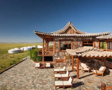 Serene early morning terrace view from Three Camel Lodge with the Gobi Desert’s expansive landscape in the background, highlighting the tranquil nomadic retreat.