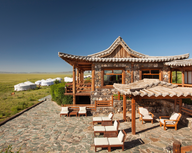 Serene early morning terrace view from Three Camel Lodge with the Gobi Desert’s expansive landscape in the background, highlighting the tranquil nomadic retreat.