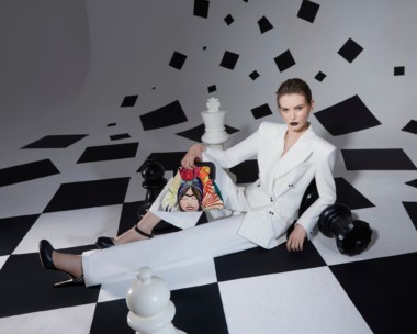 Bold black and white geometric forms create a striking composition in Metaphorical Geometries by J'ESSENTIA. A model wearing white suit from J'Essentia