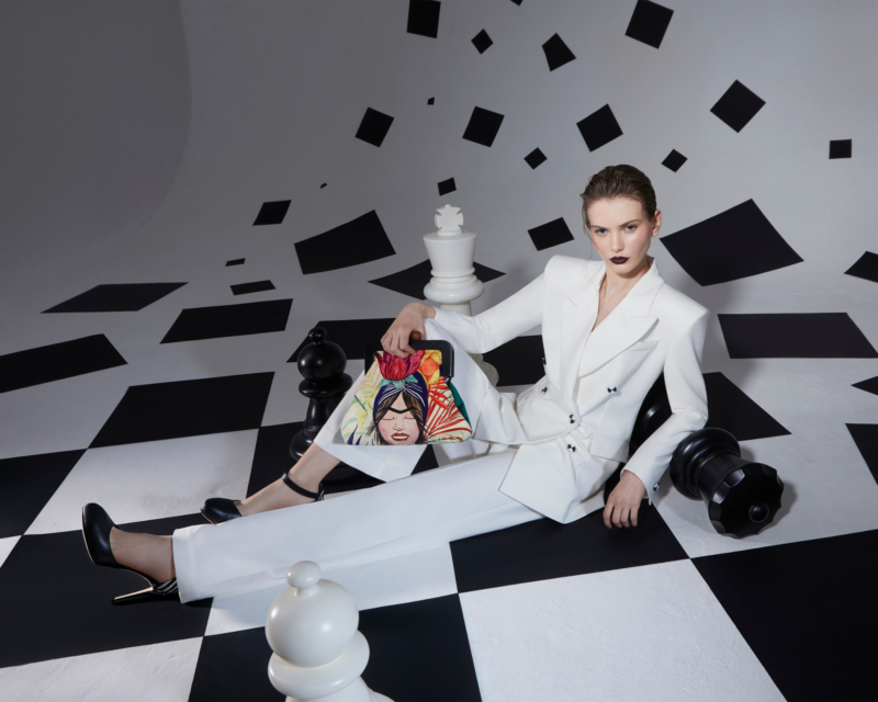 Bold black and white geometric forms create a striking composition in Metaphorical Geometries by J'ESSENTIA. A model wearing white suit from J'Essentia