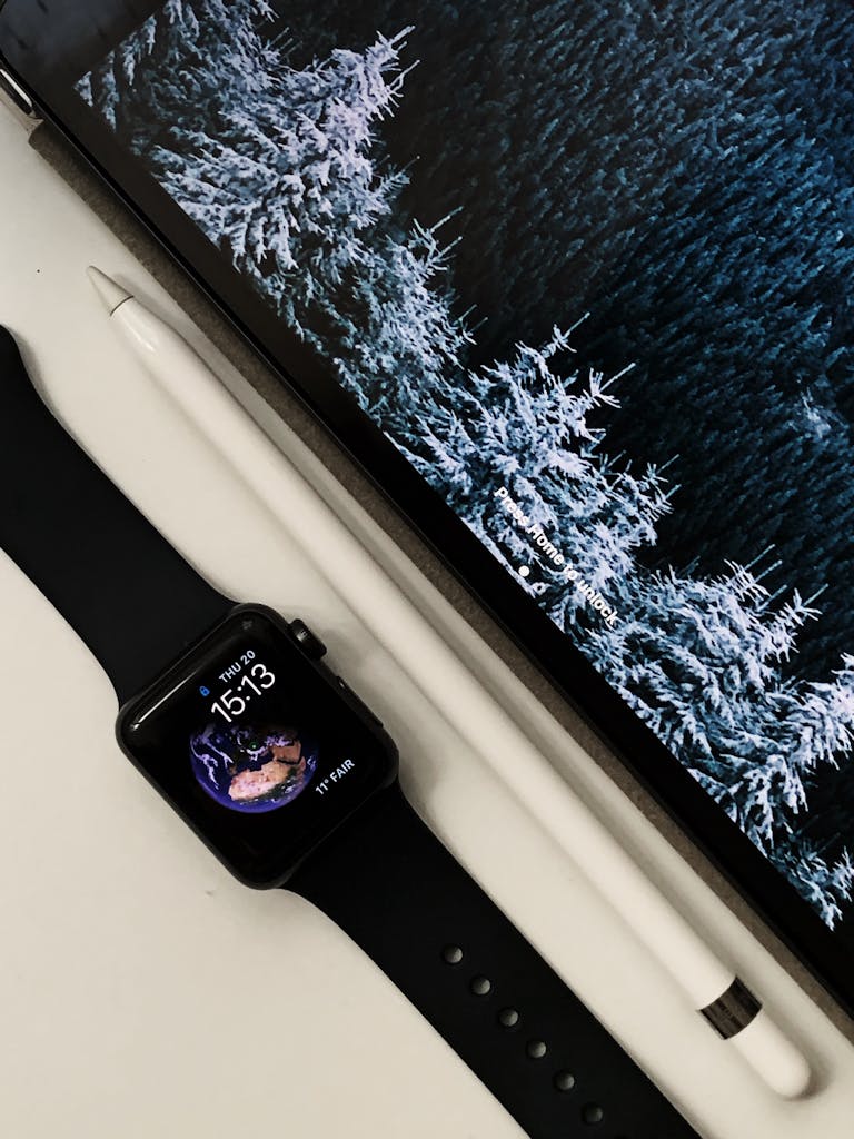Flat Lay Photo of Black Apple Watch Beside Stylus Pen