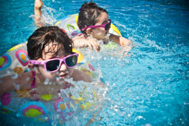 2 girls swimming during summer daytime