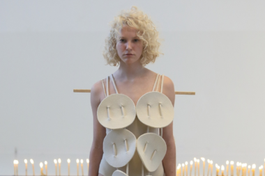 Fashion model presenting DZHUS SS25 collection at Berlin Fashion Week 2024, highlighting unique textures and bold style