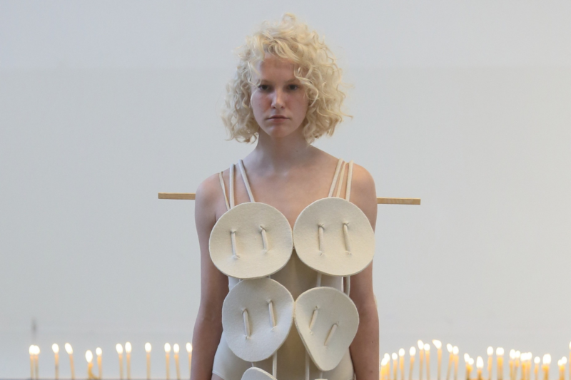 Fashion model presenting DZHUS SS25 collection at Berlin Fashion Week 2024, highlighting unique textures and bold style