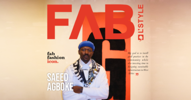 Saeed Agboke, the founder of Geschwister, standing in front of his brand logo background.