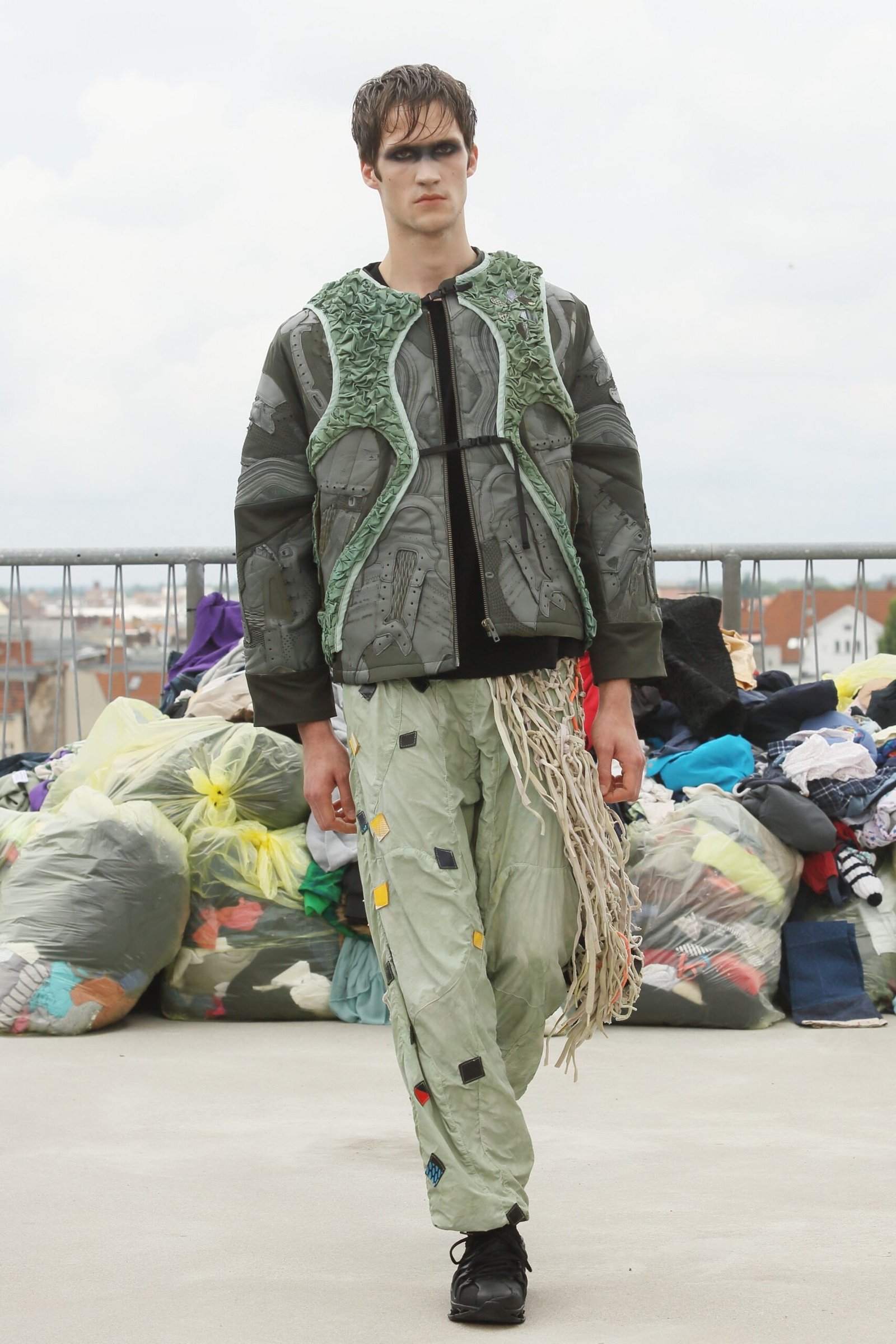 A dynamic runway scene at Berlin Fashion Week featuring the PLNGNS Sneaker Riot collection, with models striding in stylish streetwear and eye-catching sneakers.