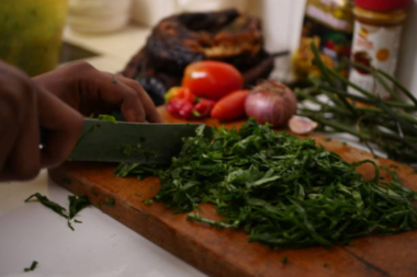 A chef preparing Marugbo Leaves in the kitchen