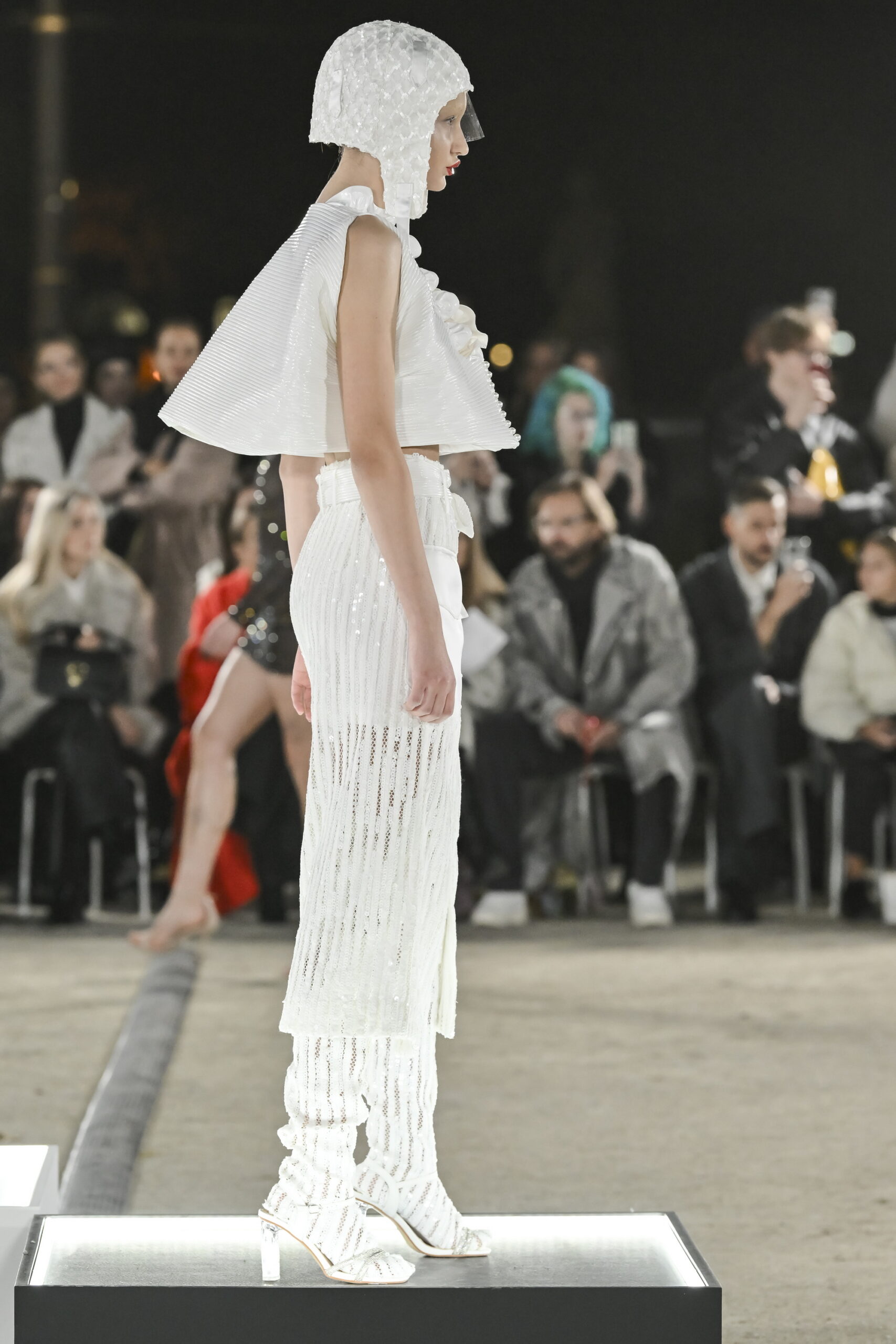 Models on a chessboard-inspired runway during Mercedes-Benz Fashion Live! 2024