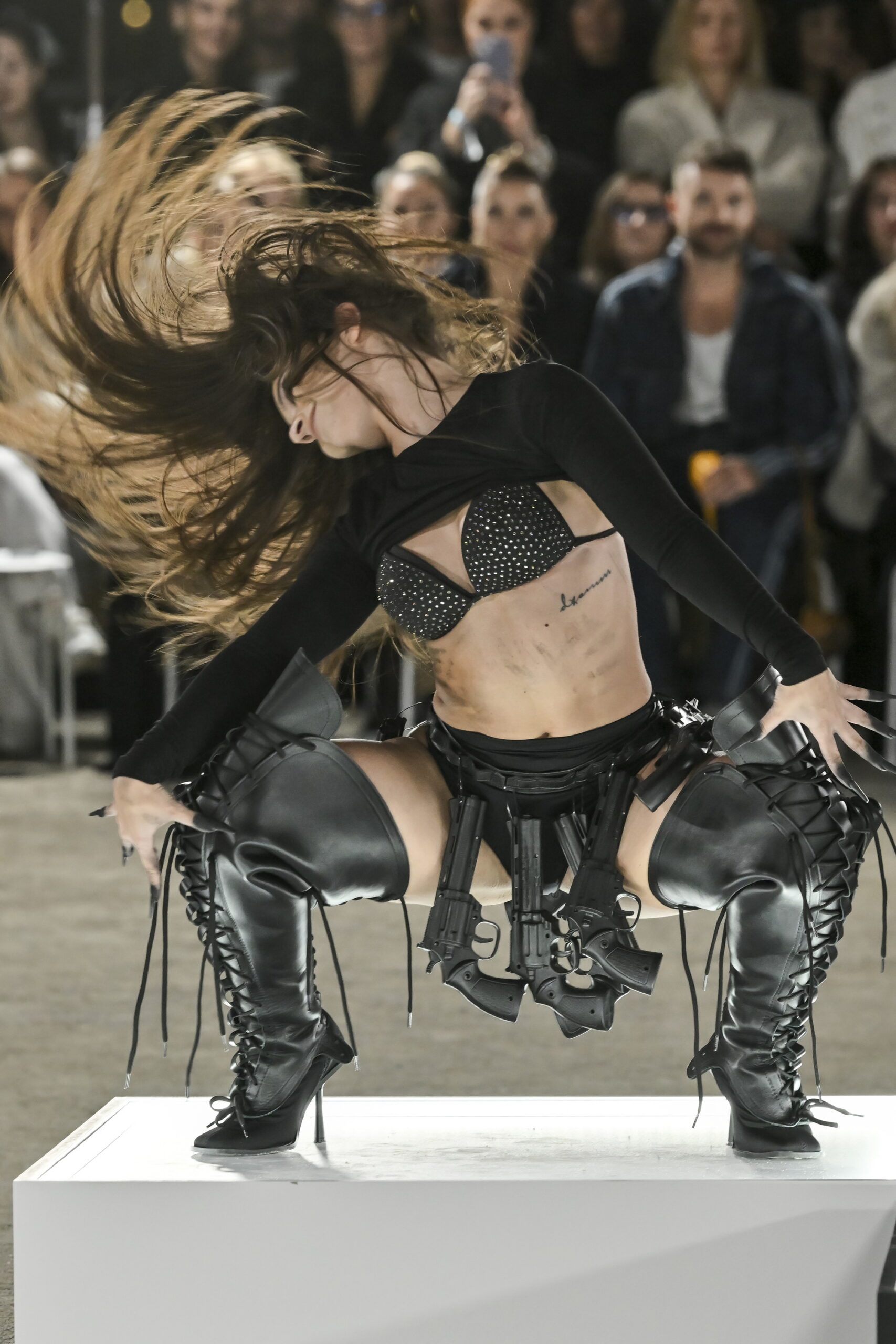Models on a chessboard-inspired runway during Mercedes-Benz Fashion Live! 2024