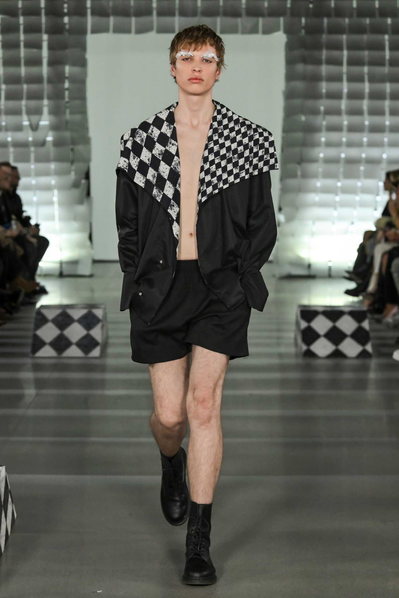 Pavol Dendis showcases circus-inspired collection FOOLS, combining precise tailoring with innovative patterns at MB Fashion Live.