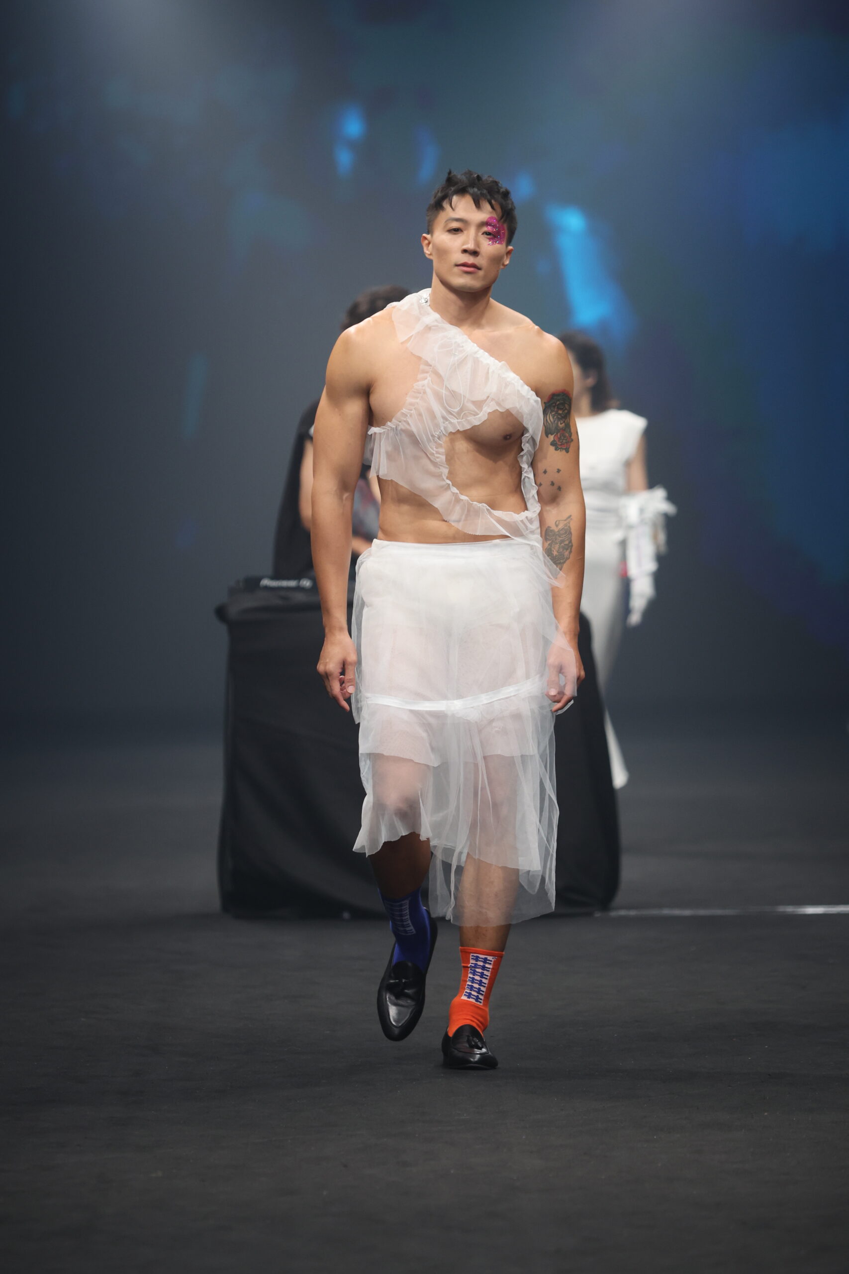 Model showcasing a gender-fluid outfit from #DAMUR's SS25 collection, inspired by love and upcycled fashion