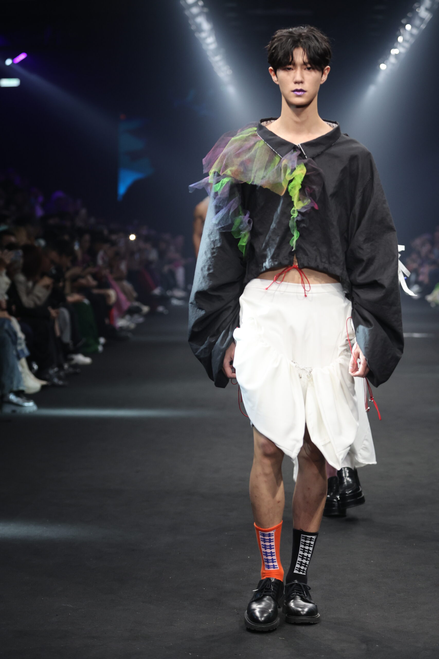 Model showcasing a gender-fluid outfit from #DAMUR's SS25 collection, inspired by love and upcycled fashion