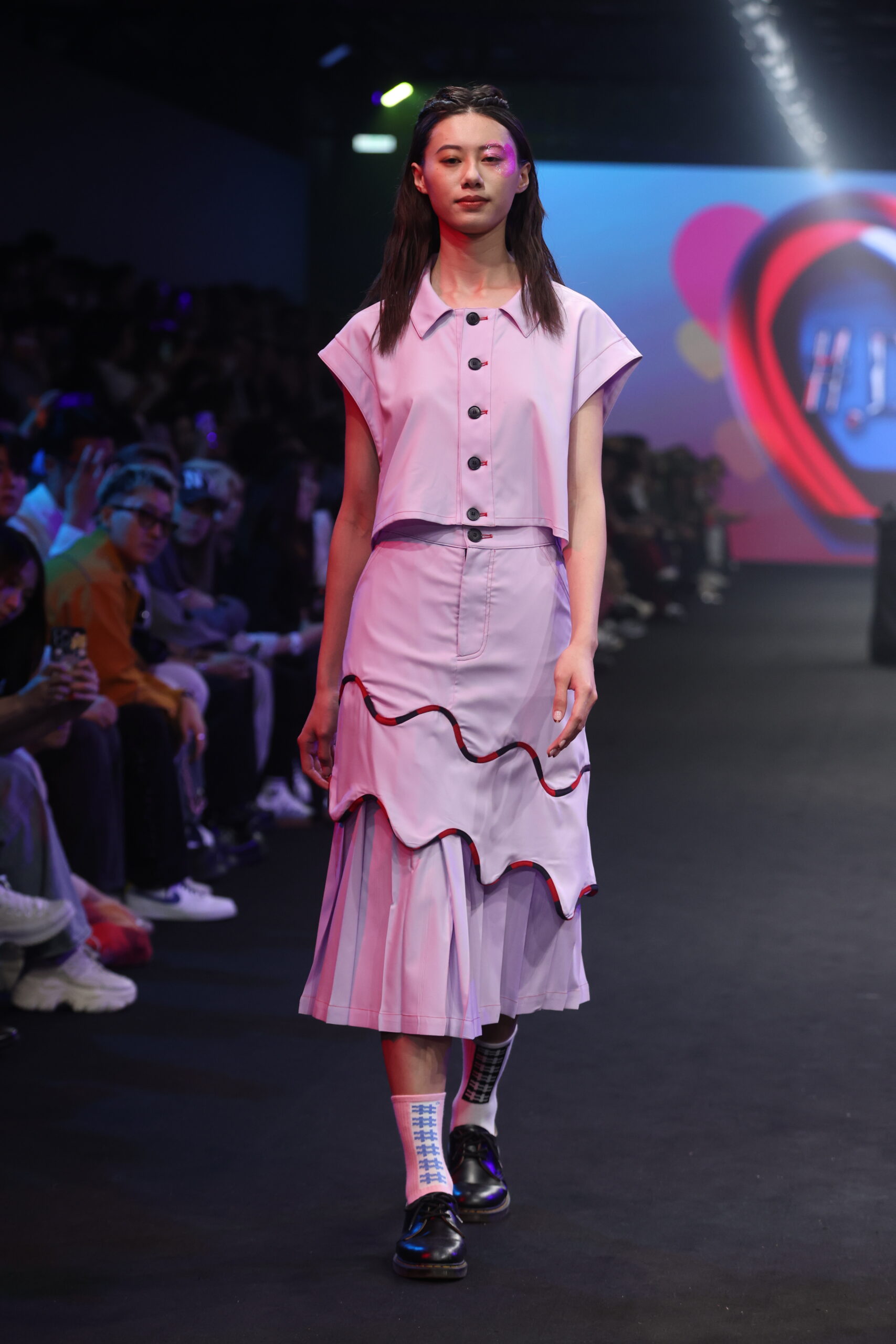 Model showcasing a gender-fluid outfit from #DAMUR's SS25 collection, inspired by love and upcycled fashion