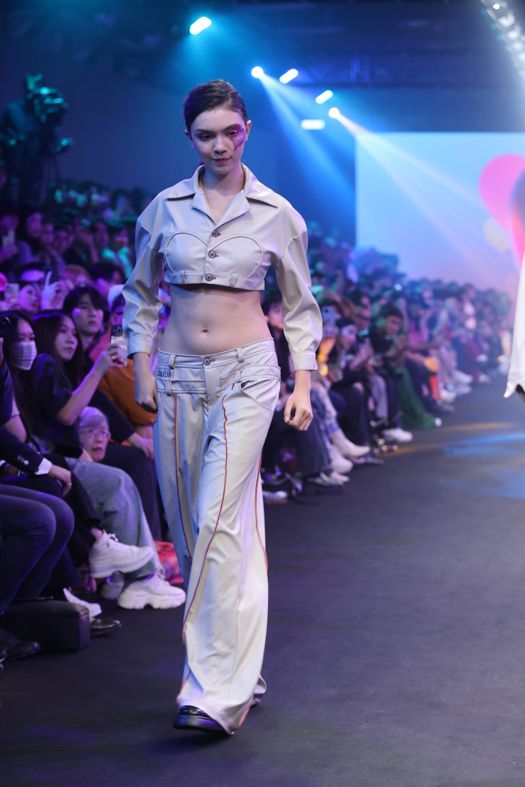 Model showcasing a gender-fluid outfit from #DAMUR's SS25 collection, inspired by love and upcycled fashion