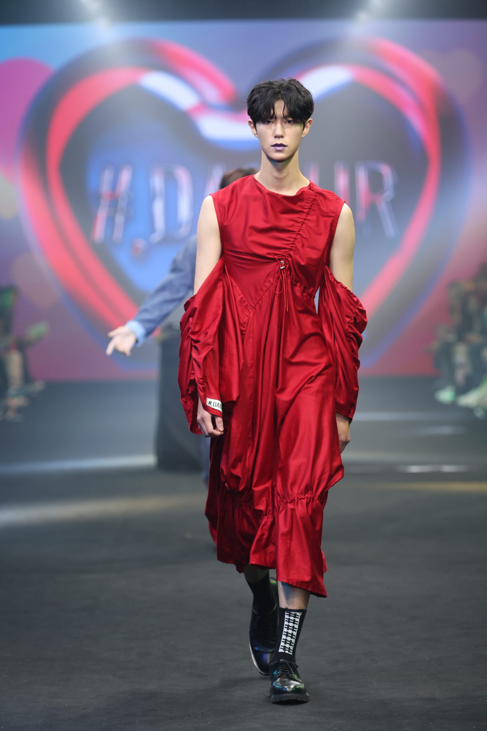 Model showcasing a gender-fluid outfit from #DAMUR's SS25 collection, inspired by love and upcycled fashion