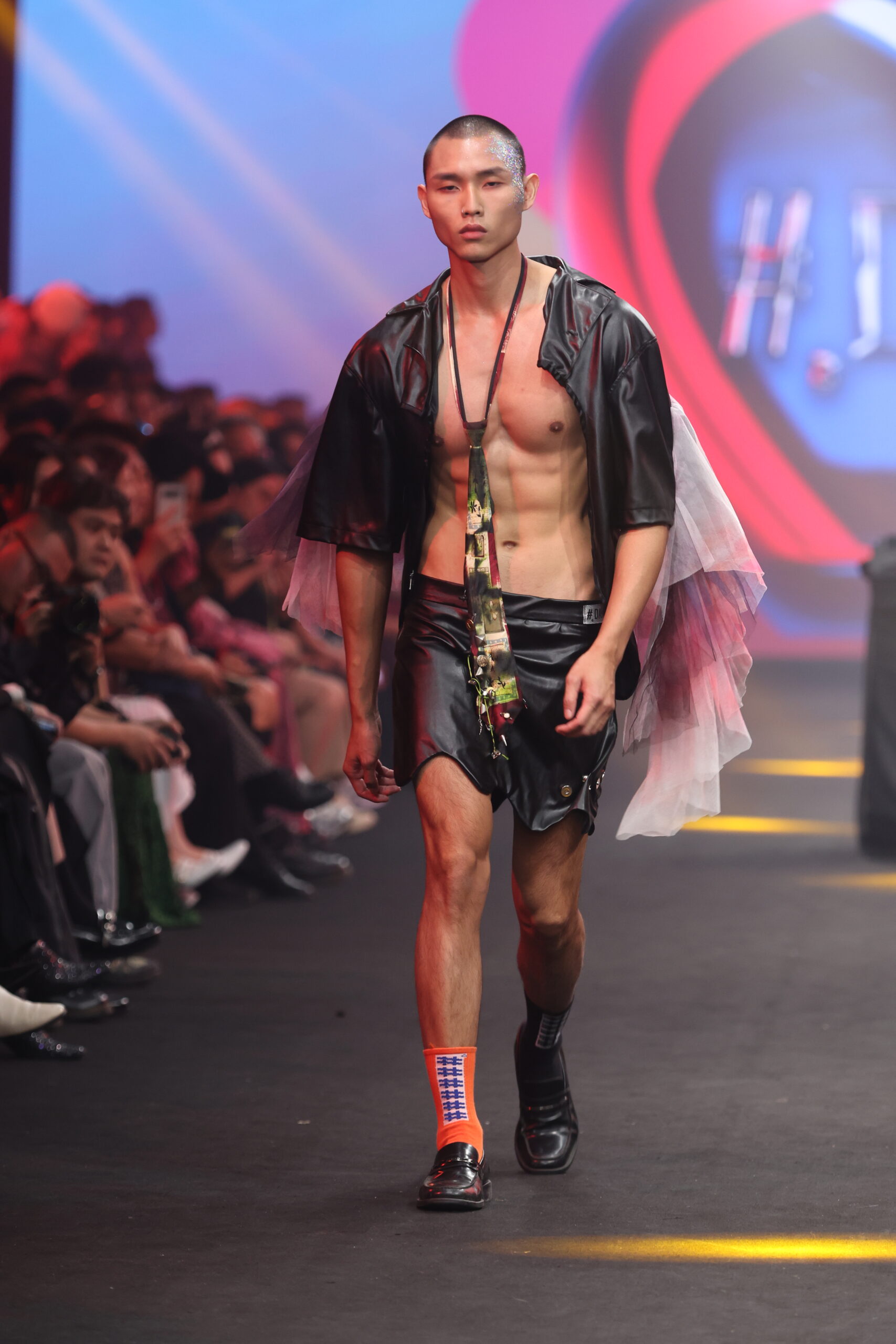 Model showcasing a gender-fluid outfit from #DAMUR's SS25 collection, inspired by love and upcycled fashion