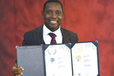 Prince Adeniyi with an award recognising his work in promoting climate advocacy through art.