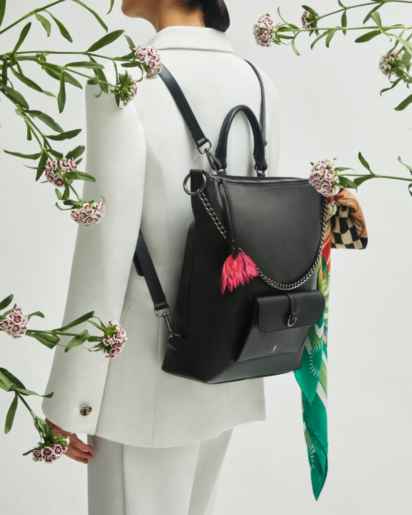 A vibrant leather bag from J'ESSENTIA's PrimavERA collection featuring geometric shapes and lotus charm details.