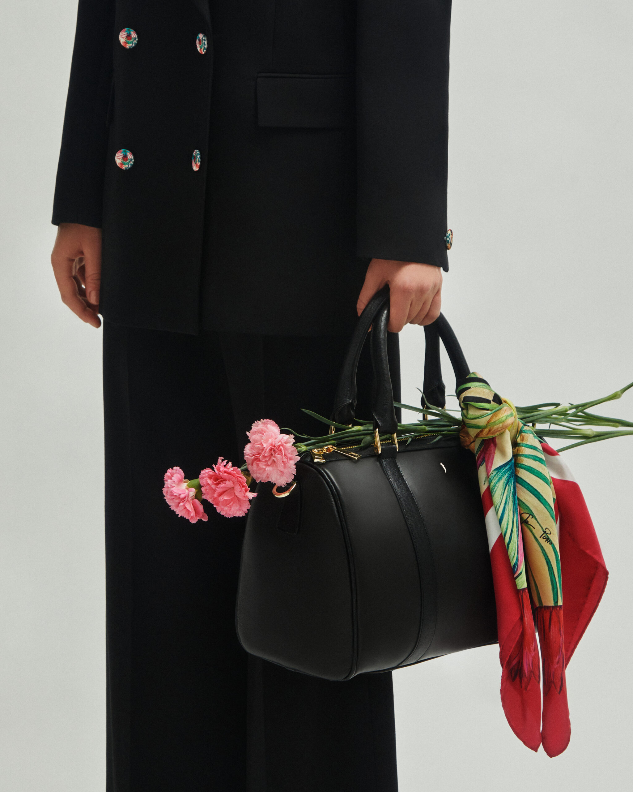 Luxury accessories showcasing fringes made from leather scraps, emphasizing J'ESSENTIA's commitment to sustainability.