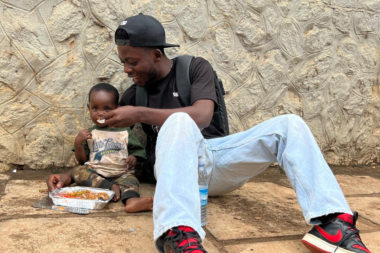 Shabani Chani feeding a homeless child in Uganda