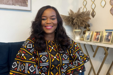 Nigerian female artist Chinyere Ibenye creating a colourful artwork.