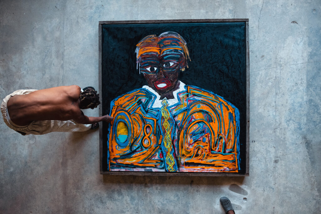 Selassie in his studio working on a new art piece