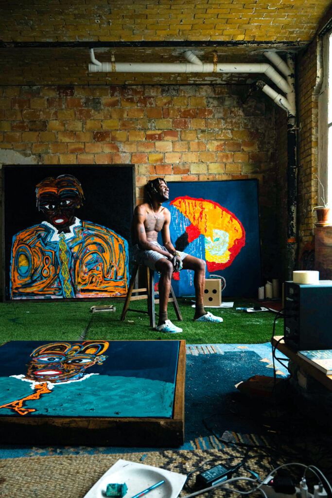 Selassie in his studio working on a new art piece