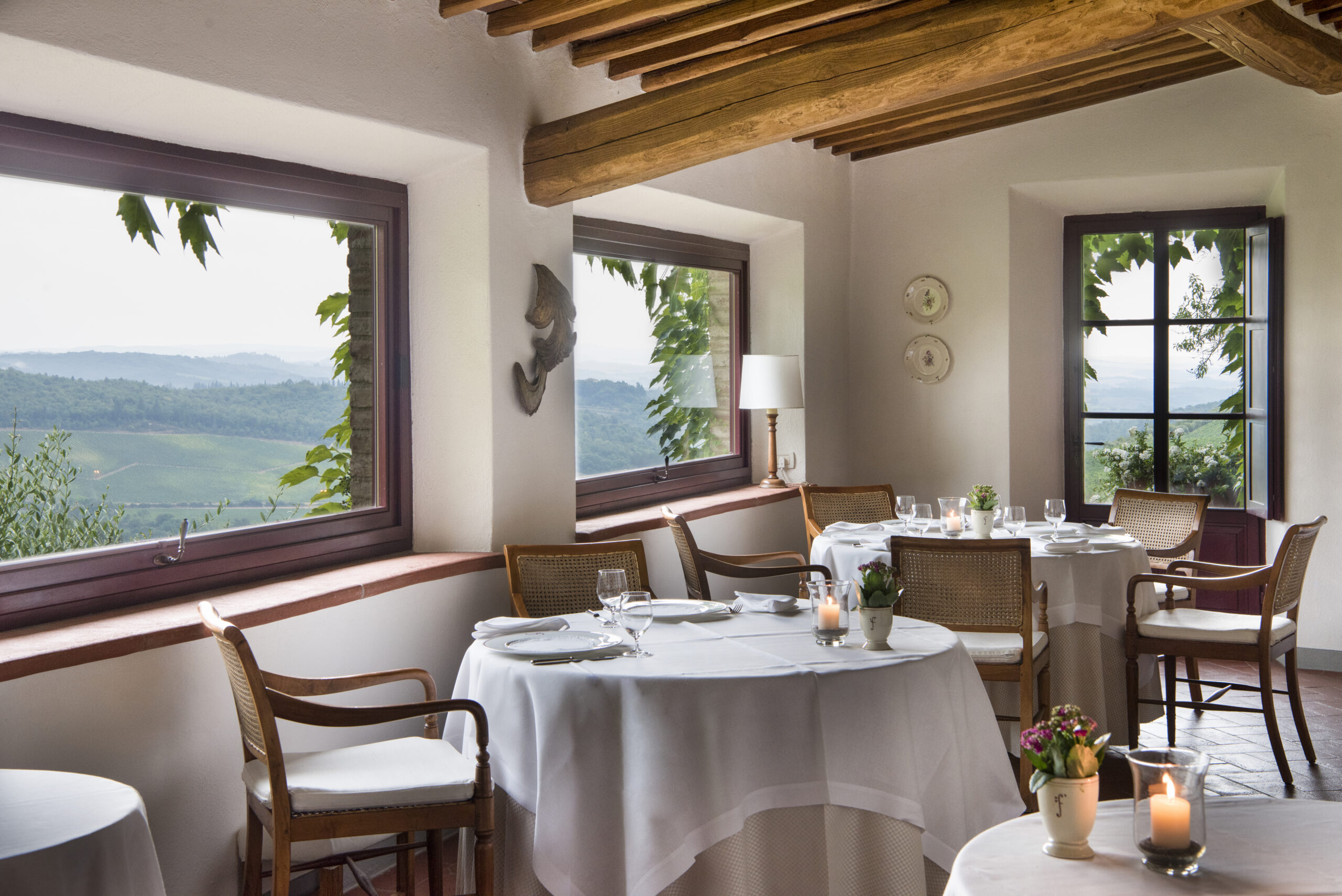 La Colonna restaurant at Hotel Le Fontanelle with panoramic views of the Tuscan hills in Chianti.