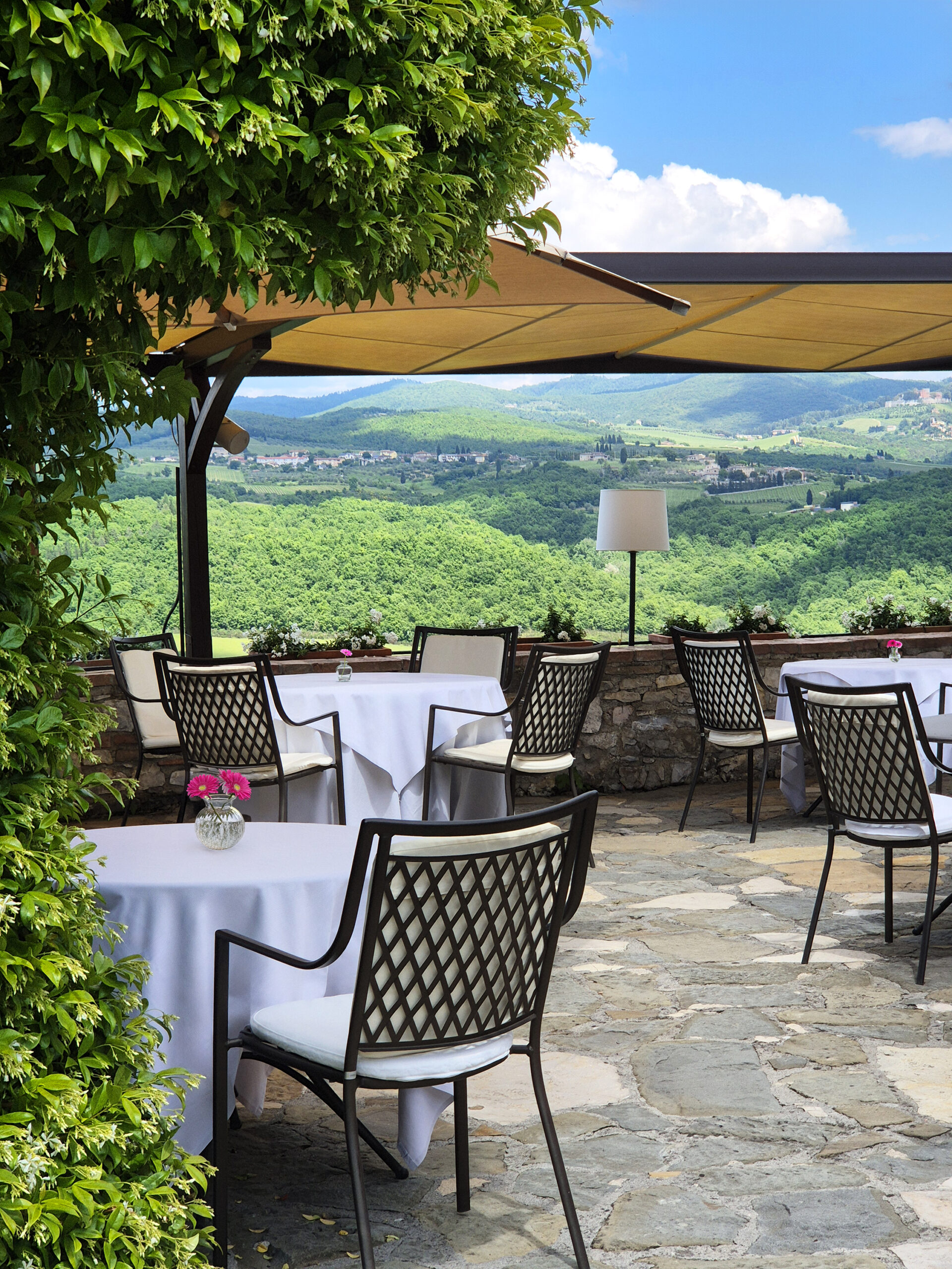 La Colonna restaurant at Hotel Le Fontanelle with panoramic views of the Tuscan hills in Chianti.