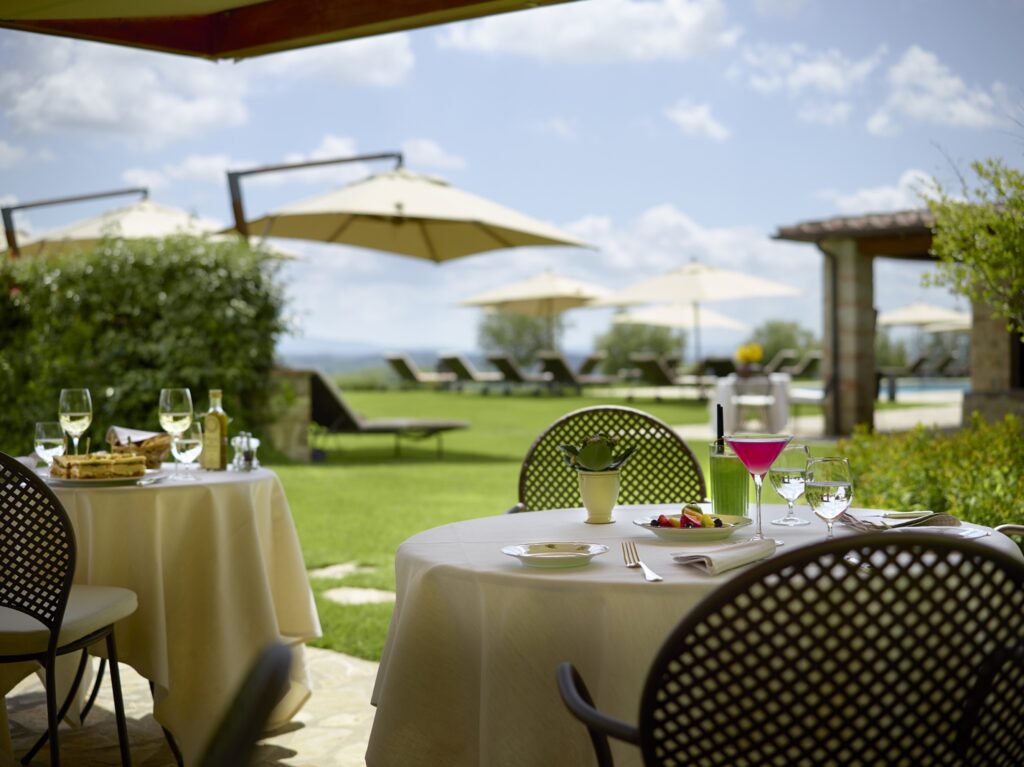 La Colonna restaurant at Hotel Le Fontanelle with panoramic views of the Tuscan hills in Chianti.