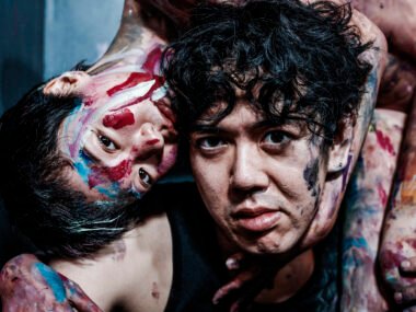 Close-up of Hirooki Hatori painting a human figure in expressive watercolour