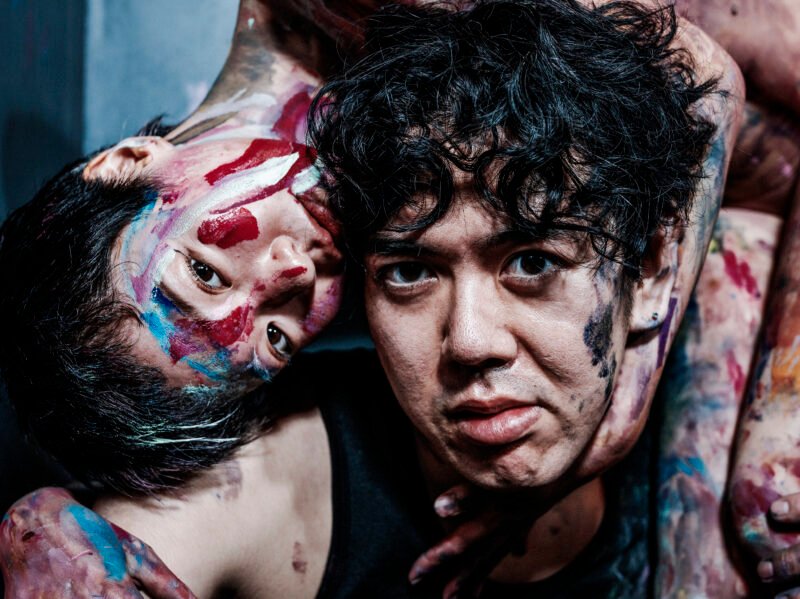 Close-up of Hirooki Hatori painting a human figure in expressive watercolour