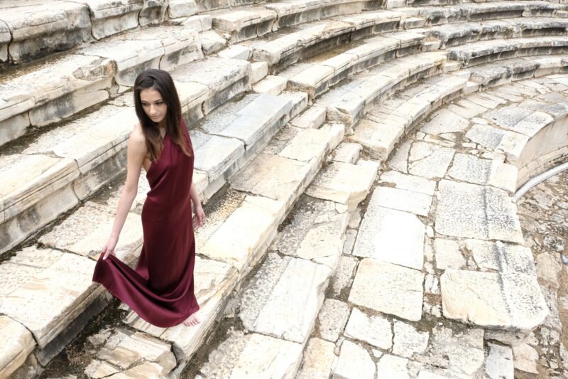 Model wearing Aelis Couture FW25/26 red couture dress inspired by Hierapolis and emotional storytelling.