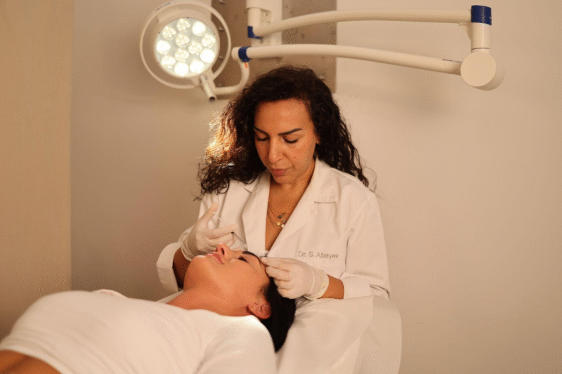 Woman with natural-looking skin receiving subtle aesthetic consultation.