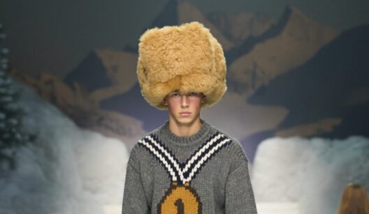 Model walking the Dsquared2 Fall Winter 2026 runway wearing oversized puffer outerwear inspired by winter sports and Canadian heritage