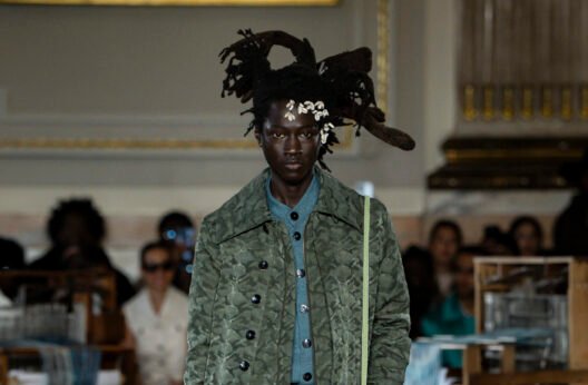 Model walking in LABRUM Autumn Winter 2026 Threads of Osmosis runway show featuring tailored silhouettes and diaspora-inspired textiles