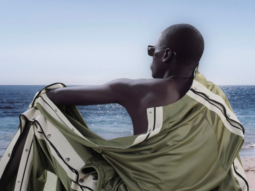 Palm Angels SS26 Island Speed campaign — motorbike suspended mid-air against the Jamaican coastline creating tension between movement and stillness